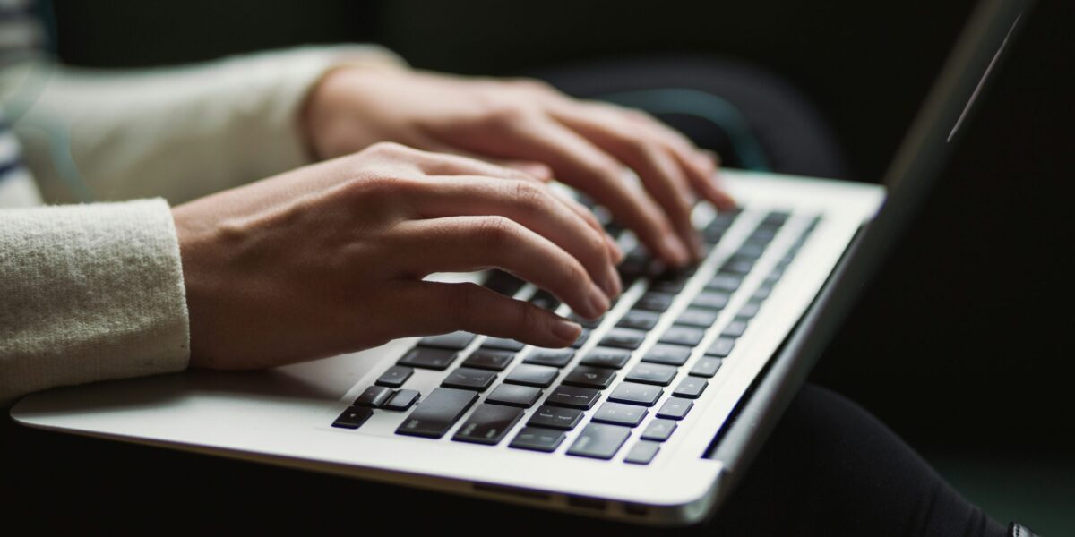 A person typing at a laptop.