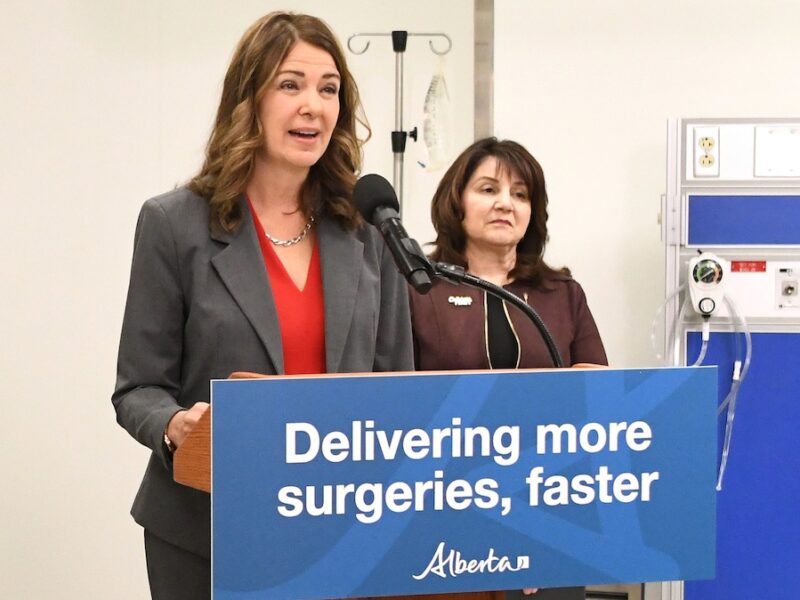 Alberta Premier Danielle Smith, seen here with Hospitals and Surgical Services Minister Adriana LaGrange, at a news conference about her plan to privatize more surgeries.