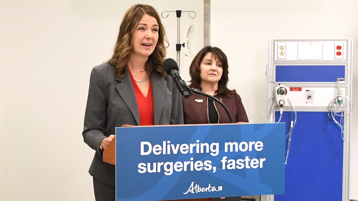 Alberta Premier Danielle Smith, seen here with Hospitals and Surgical Services Minister Adriana LaGrange, at a news conference about her plan to privatize more surgeries.