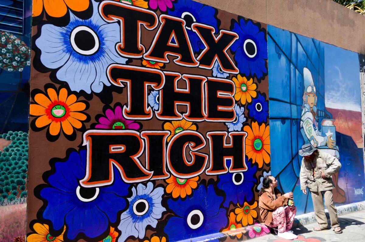 A mural with a Tax the Rich message.