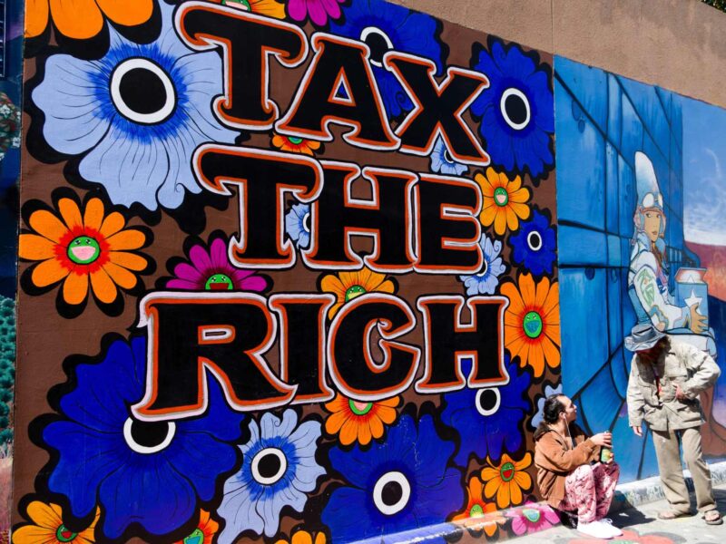 A mural with a Tax the Rich message.