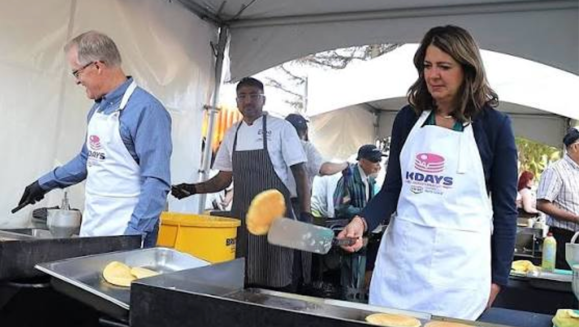 Alberta Premier Danielle Smith concentrates on flipping a pancake at the Premier’s K-Days Breakfast last Thursday as Environment Minister Grant Hunter entertains himself nearby.