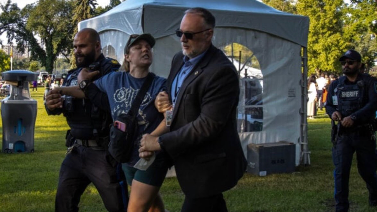 In a memetic moment captured on video, Danielle Smith’s security frog-marches an articulate protester away from the “Premier’s K-Days Breakfast” last Thursday.