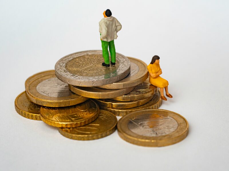 An image of two figurines sitting atop a pile of coins. Divorce ranks among the most stressful legal processes anyone faces, financially and emotionally. Your choice of lawyer will shape nearly every outcome.