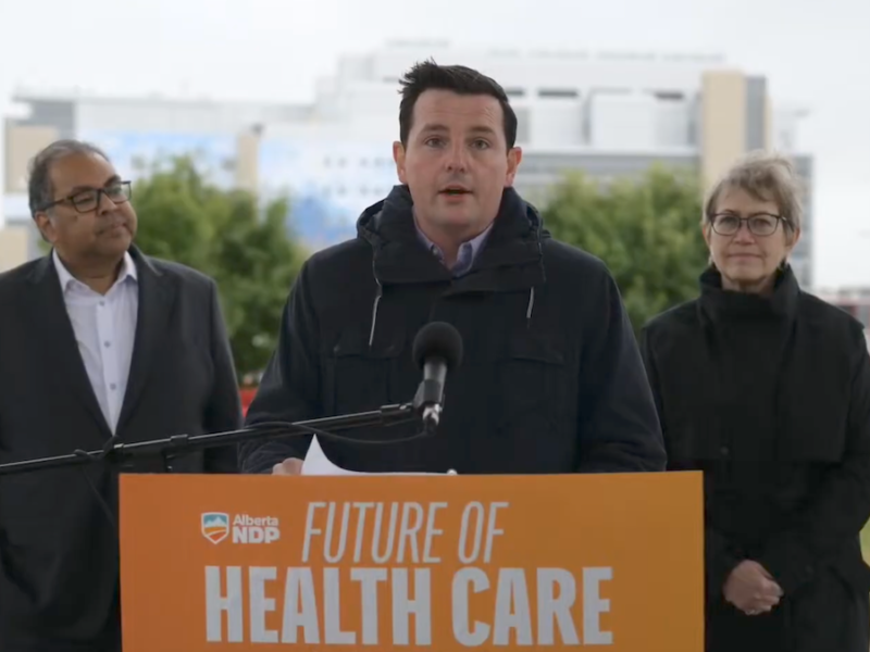 The NDP candidate in the Calgary-Shaw by-election, Kyle Campbell, is flanked by Party Leader Naheed Nenshi and Calgary Varsity MLA Luanne Metz, a physician, at a recent news conference on health care policy.