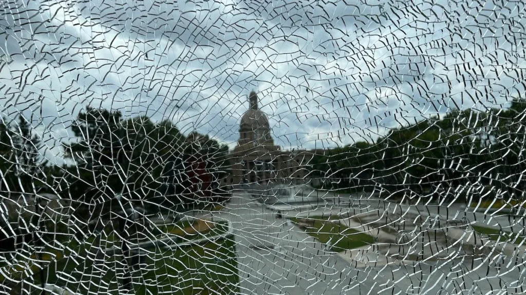 The Alberta Legislature Building through broken glass.