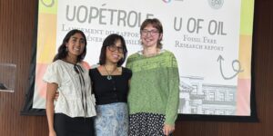 Norah Bello, Sophia Arellano and Grace Jeffries (left-to-right) stand on stage at the launch of the U of Oil report.